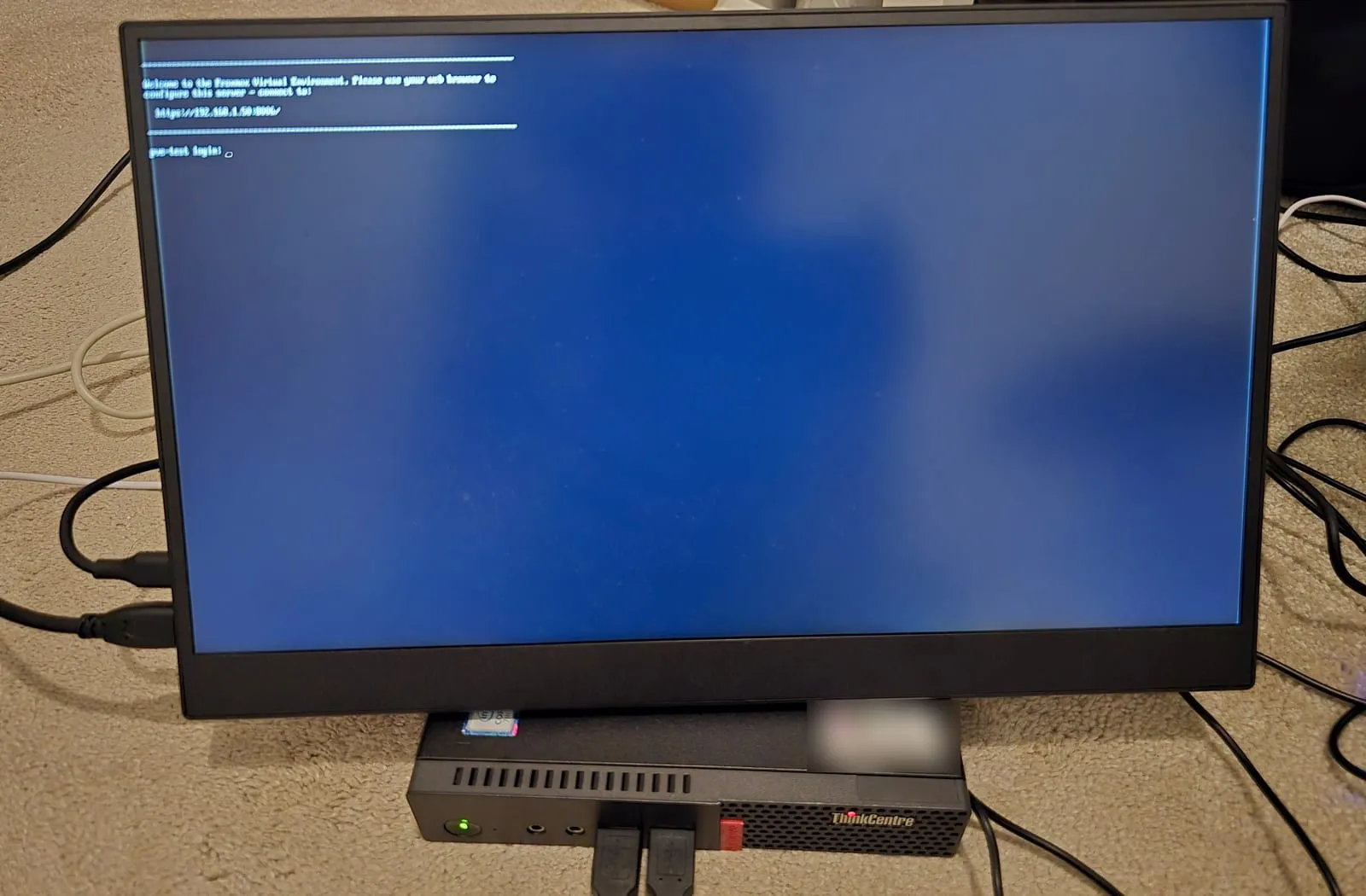 The server's first boot, showing the address https://192.168.1.50:8006/ and a login prompt