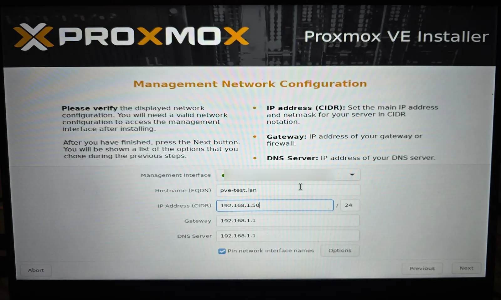 The Proxmox installer's network screen: hostname pve-test.lan, IP address 192.168.1.50/24, gateway and DNS 192.168.1.1